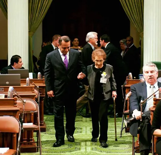 Gil Cedillo holding hands of his mother, Mary Ruiz Cedillo.