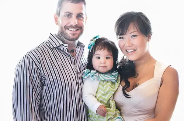 Michael Fanone and Hsin-Yi Wang with their daughter.